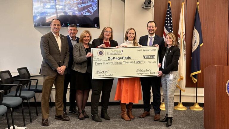 DuPage County board and DuPage Foundation members hold giant check supporting DuPagePads