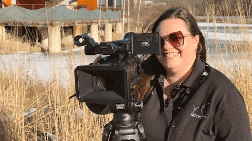 Angela Hager behind a camera at Knoch Knolls