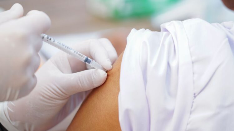 Close up of someone getting vaccination in upper arm