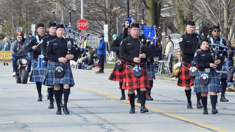 A group of bagpipers marching and performing in Naperville's St. Patrick's Day parade.
