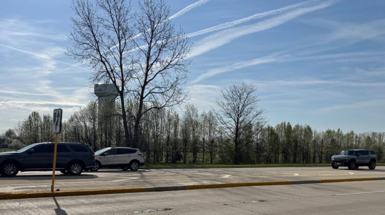 Wide shot of water tower and land/trees next to Route 59 just south of 103rd street, where Tower Court affordable housing will be built