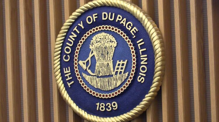 DuPage County Board seal on wall for story about board members seeking report on corrections protocol following settled lawsuit