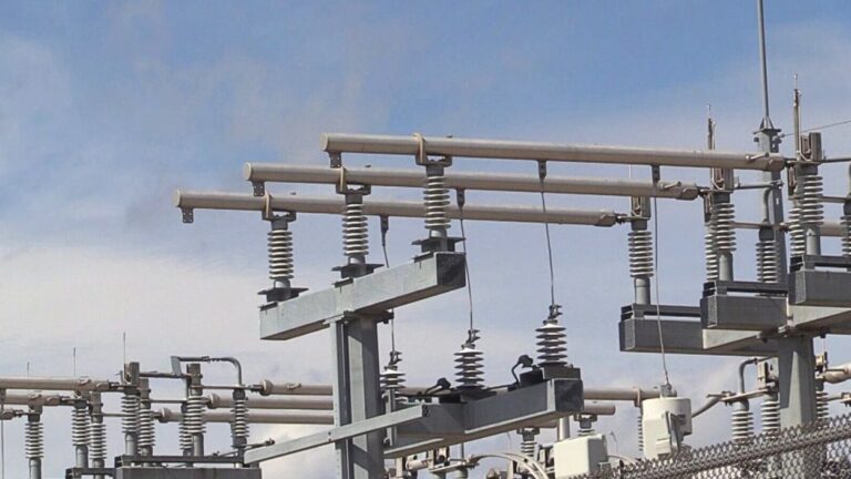 Electric posts and wires at power plant.