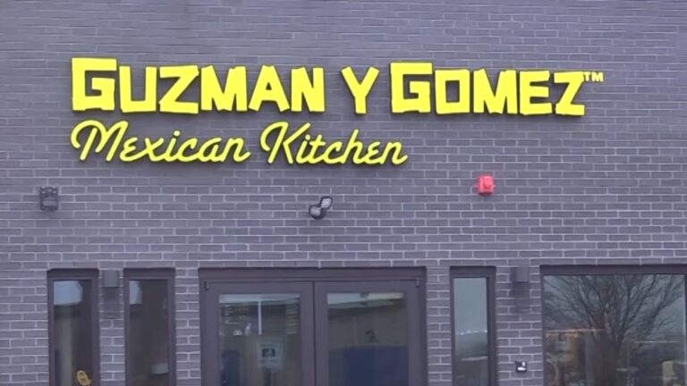 Close up of Guzman y Gomez restaurant sign at first Naperville location