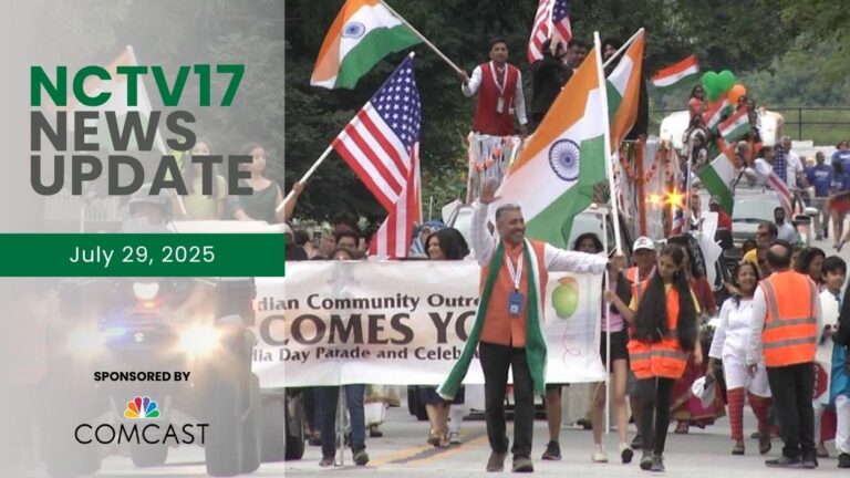 People holding flags walk in the city's India Day Parade.