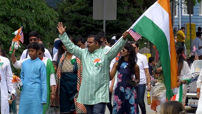 A man waves an Indian flag as he takes part of the annual India Day Parade and celebration.