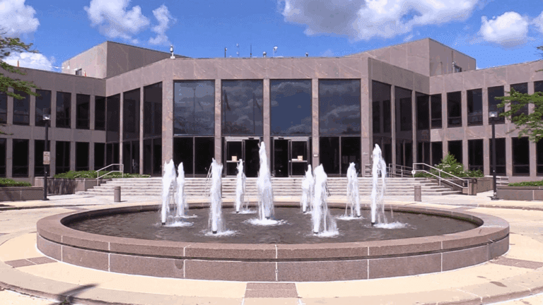 Straight on photo of the Naperville Municipal Center with the fountain in the foreground