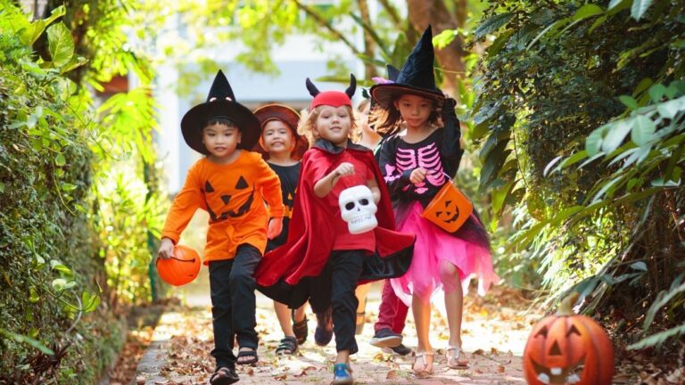 Group of trick-or-treaters walking on a sidewalk