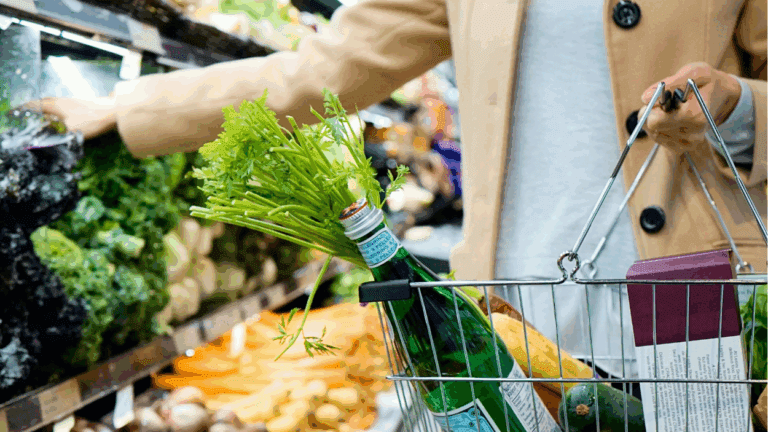 Woman putting groceries in a basket